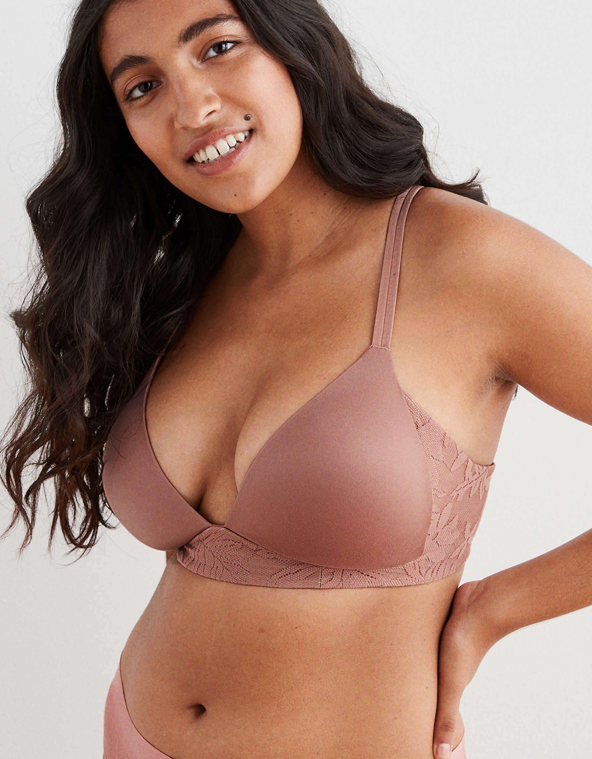 person wearing a light brown wireless bra that looks like i has the coverage and support of a traditional wired bra, floral pattern on band