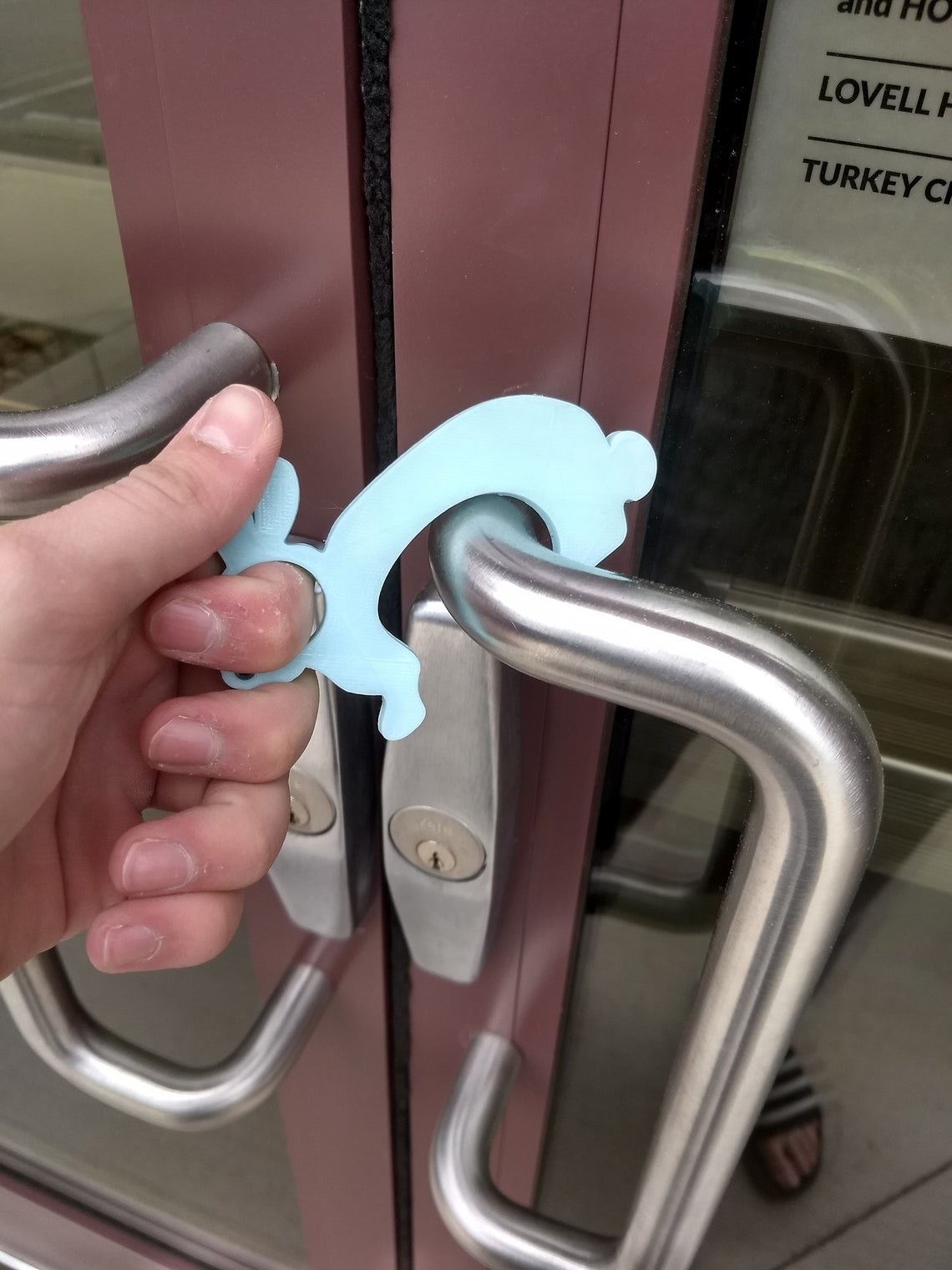 person using the door opener on a public door