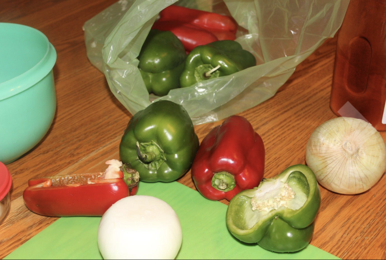 A produce saving bag with peppers inside of it