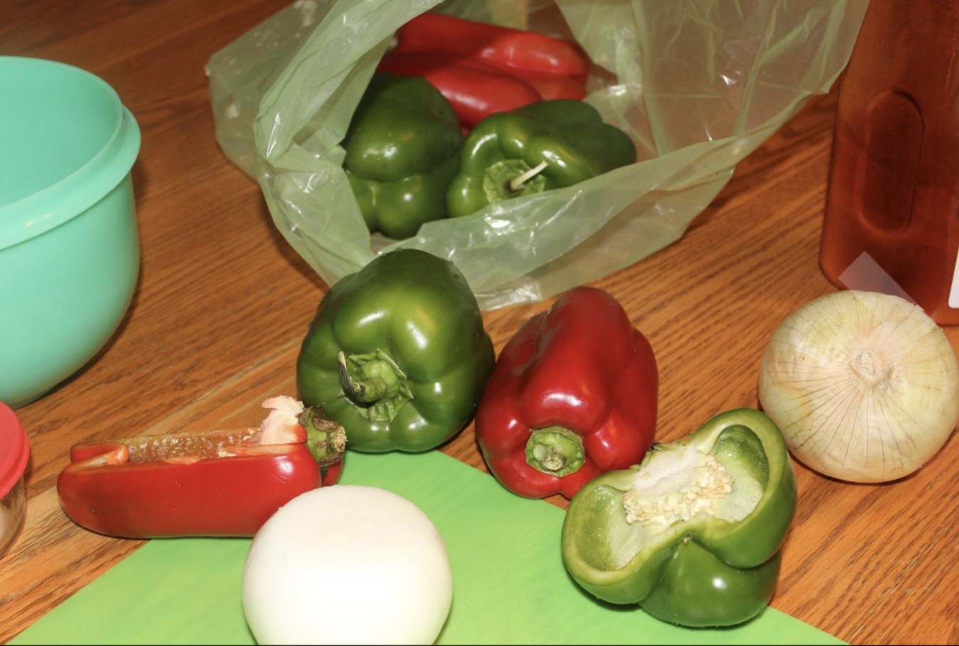 A produce saving bag with peppers inside of it 