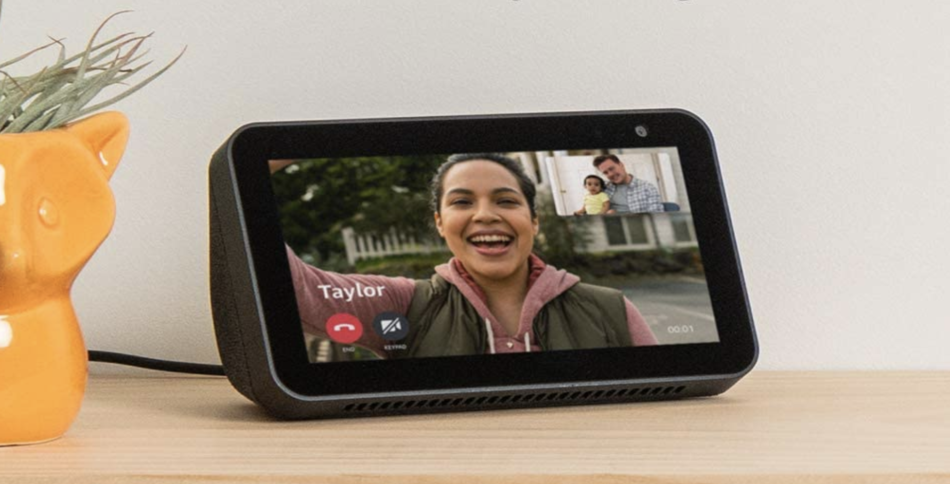 A person on the screen of an Amazon Echo Show 5 on a video call with their family from the other end 