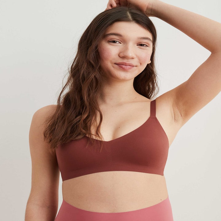 model in dark rust bralette which smooth-looking fabric  and full coverage