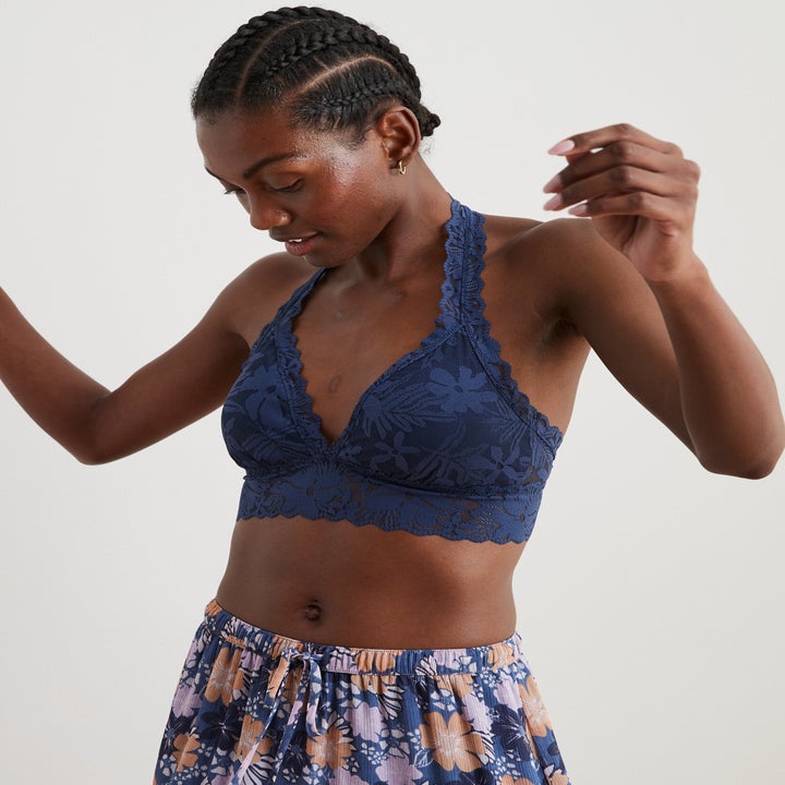 model in navy blue lace bralette with a thick lace halter strap