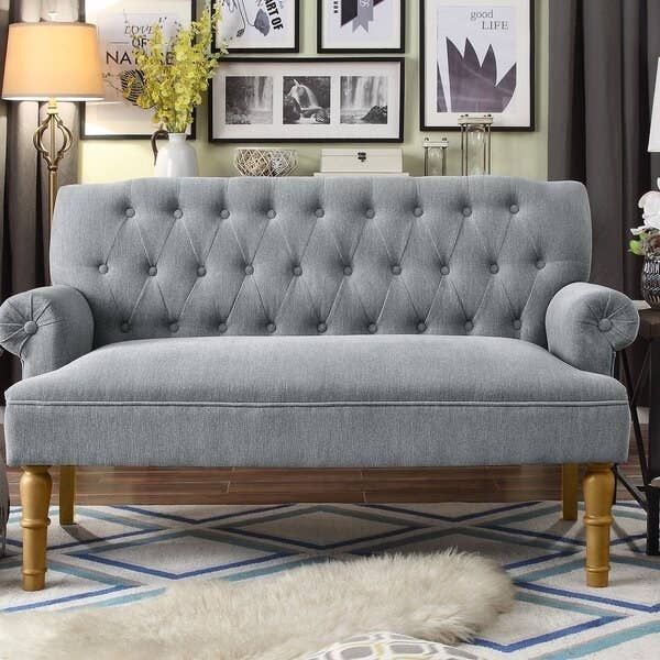 gray upholstered settee with turned maple legs, rolled arms, and enough room for about two people to sit on it.
