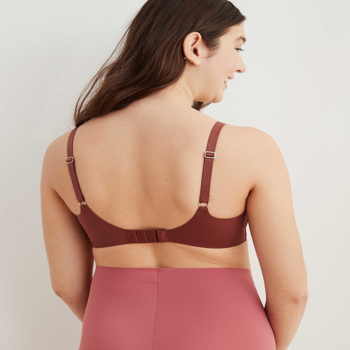 model showing the back of the bralette, which has hook and eye closure like a regular bra