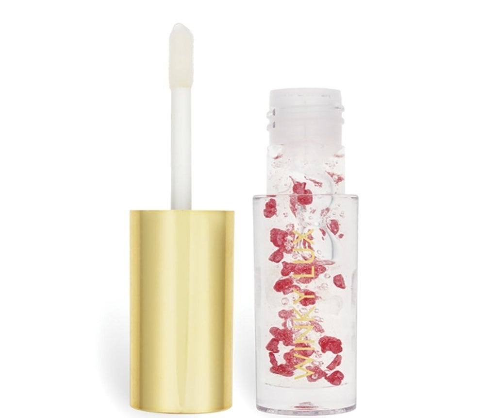 The oil in packaging that looks like a small tube of lipgloss, with an applicator on the cap. The oil itself is clear with pretty red heart-shaped petals floating inside