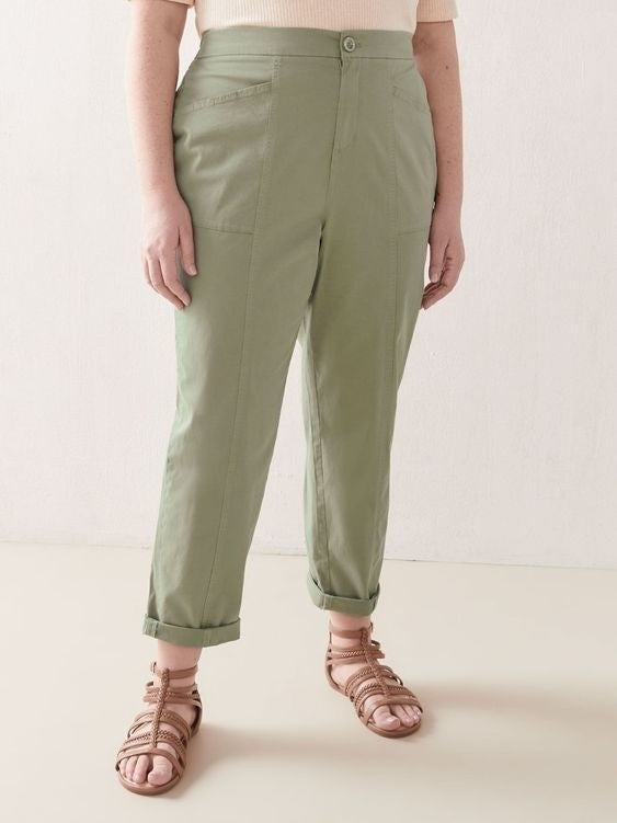 A model wearing the olive green pants with pockets
