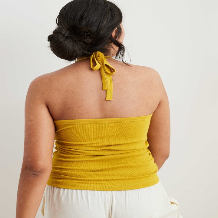 model showing the back of the tank whose straps tie at the neck