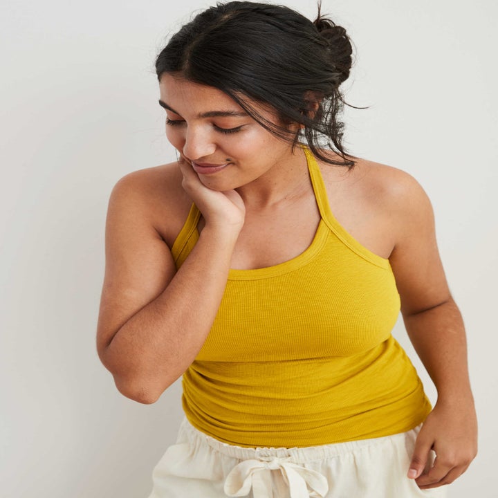 model in mustard yellow ribbed halter tank