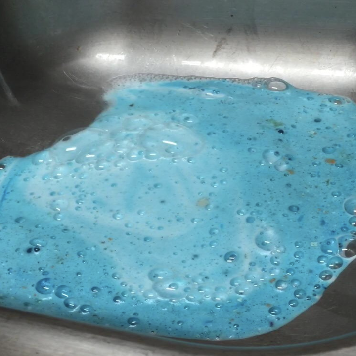 sink filled with blue liquid