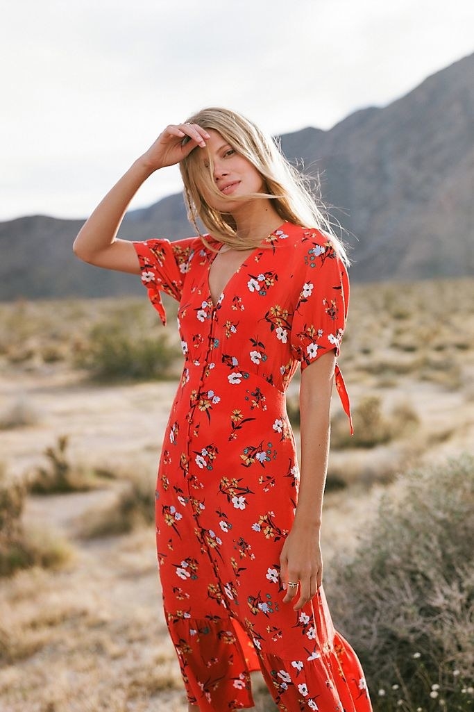 Model wearing the midi dress in bright red. 