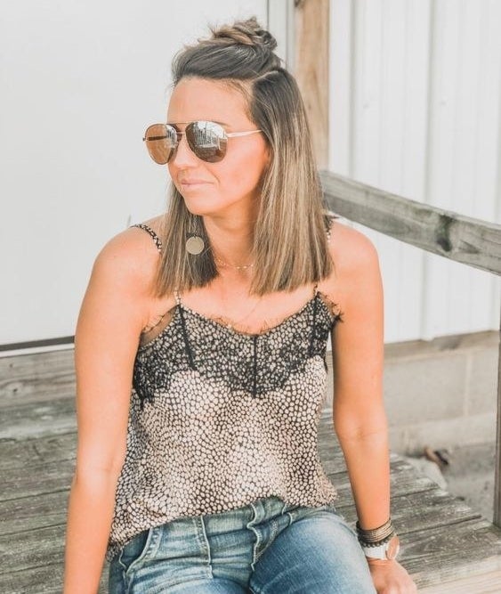 A reviewer wearing the silky cami in a snakeskin pattern and black lace