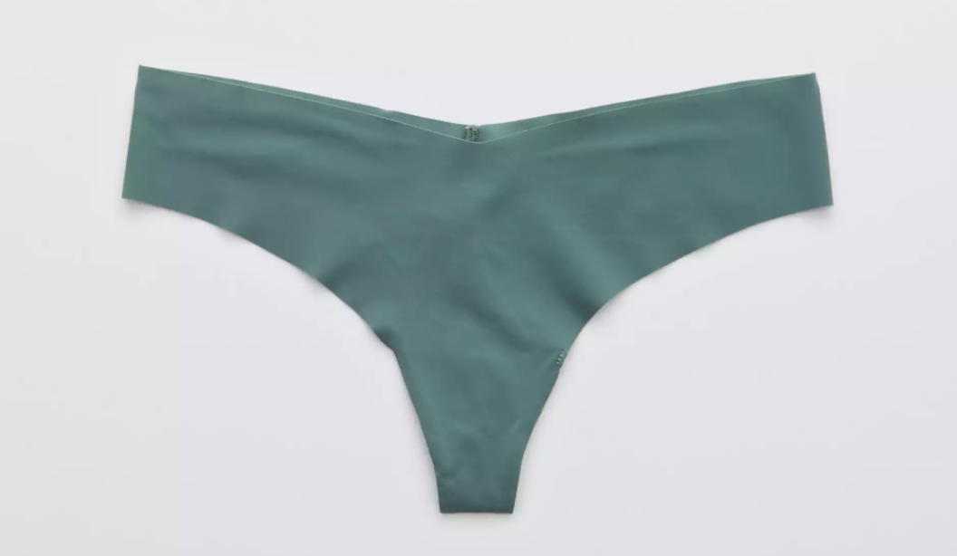 A green thong against a plain white background 