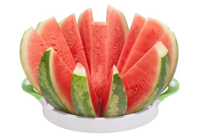 The slicer at the bottom of an opened watermelon, all cut into equally-sized slices