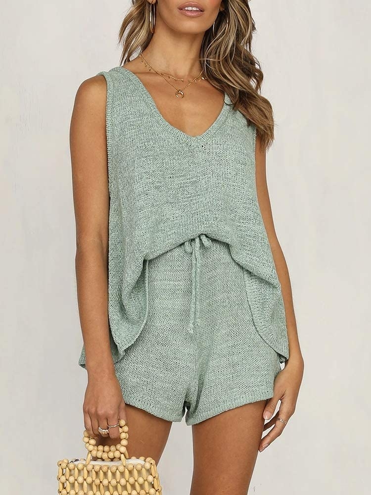 A model wearing the knit tank top and shorts set in teal