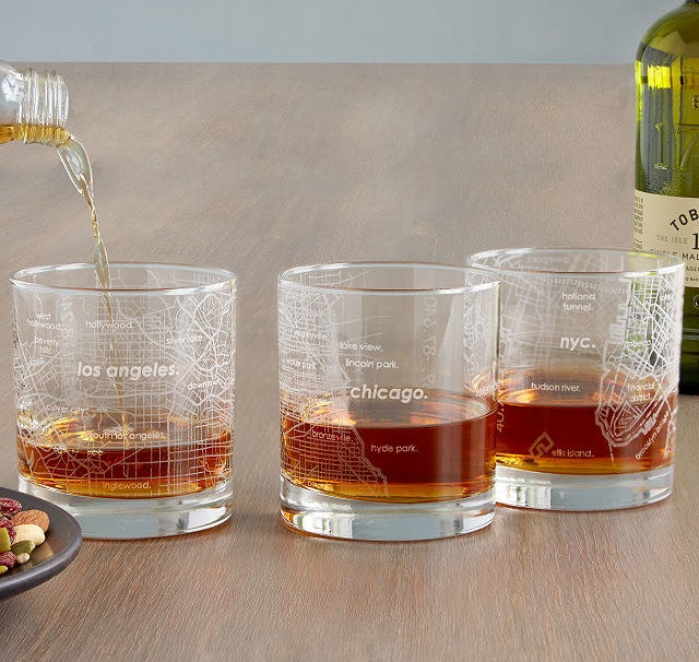 Three whiskey-size glasses etched with maps of LA, Chicago, and NYC