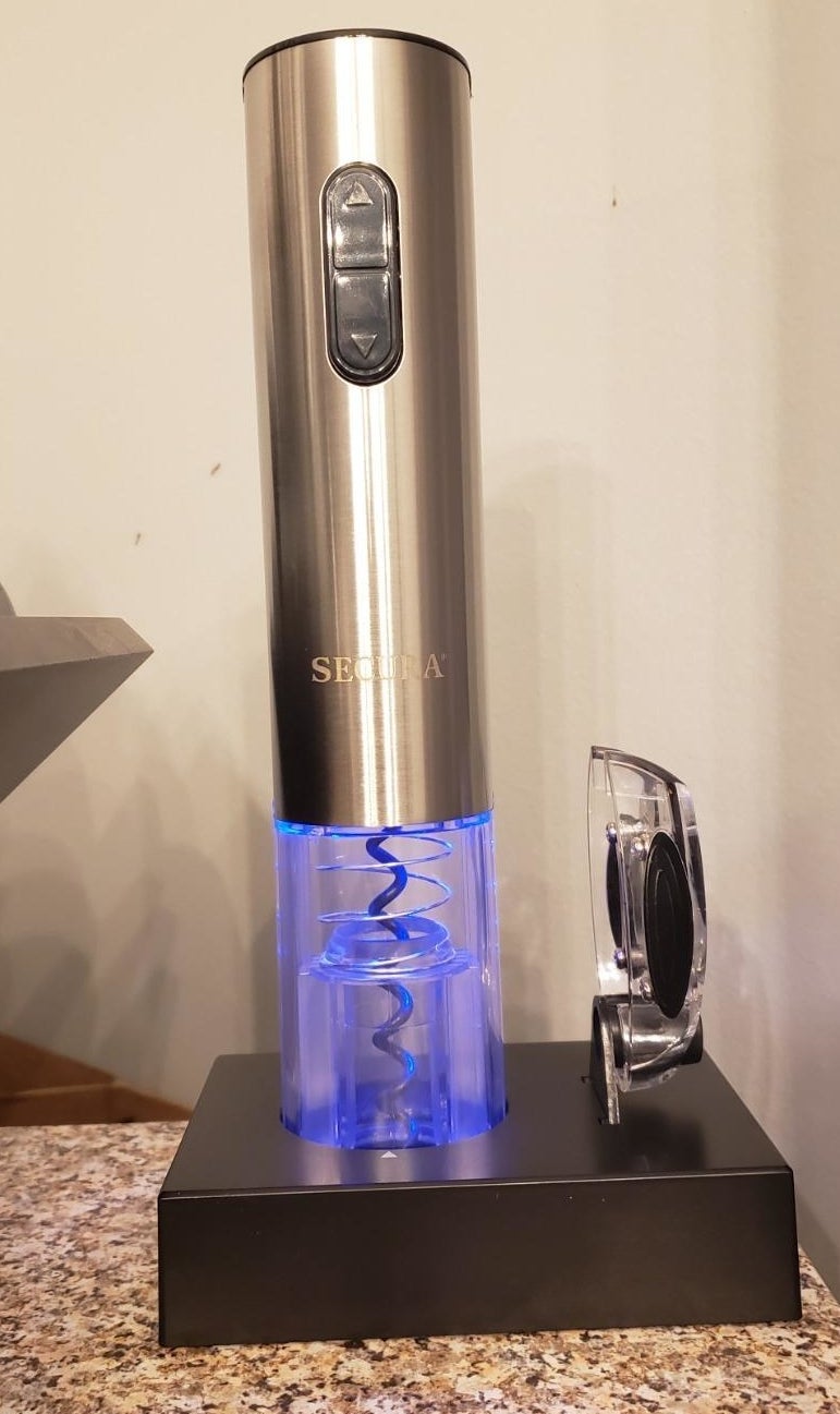 An electric wine opener the gives off a blue light