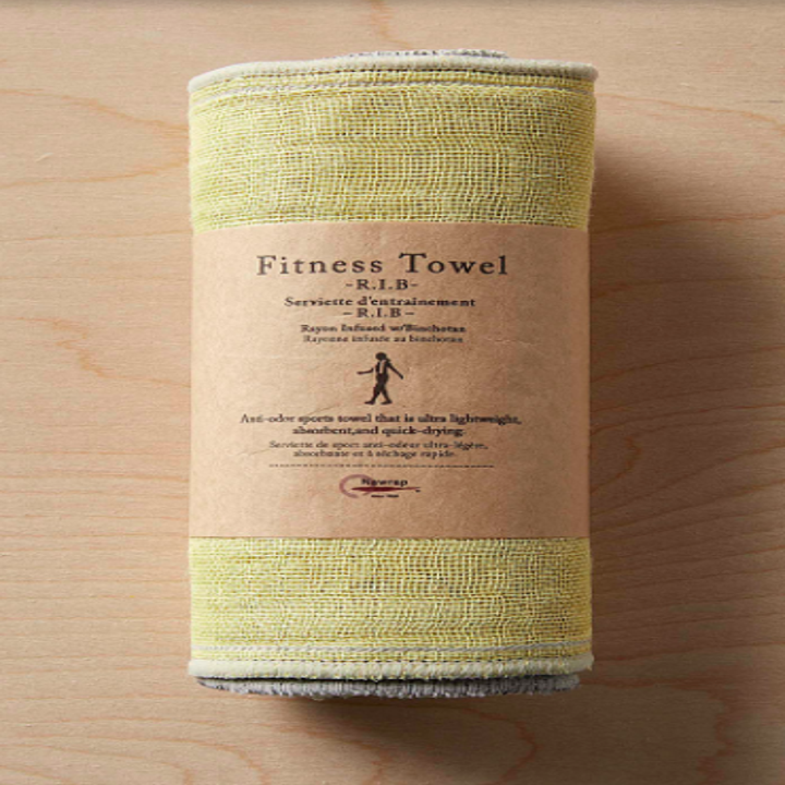 The fitness towel neatly wrapped on a wooden surface
