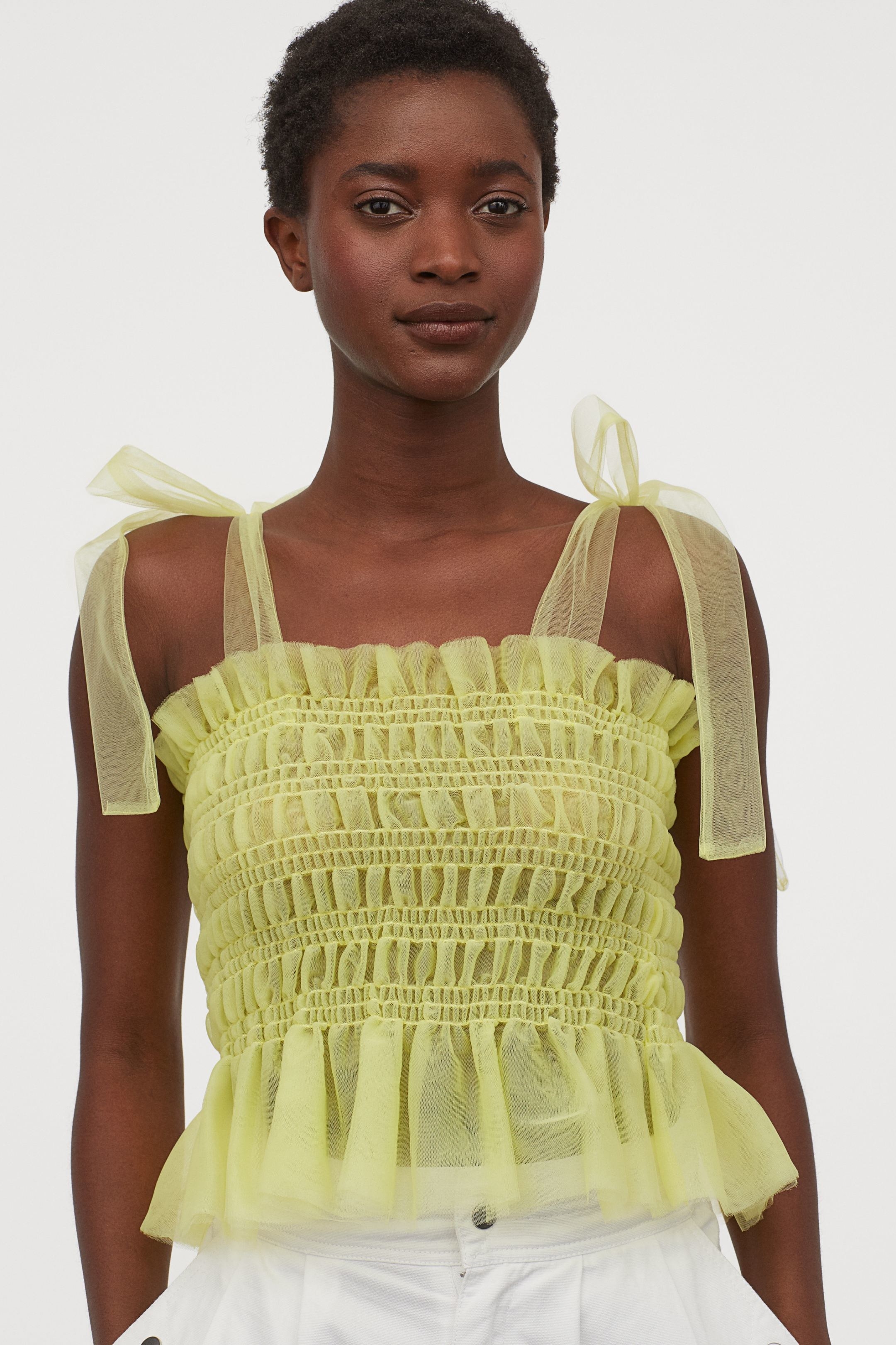 A model wearing the ruched tulle top in light yellow