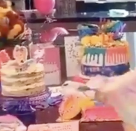 Cakes with JoJo decorations can be seen in the background of the video.