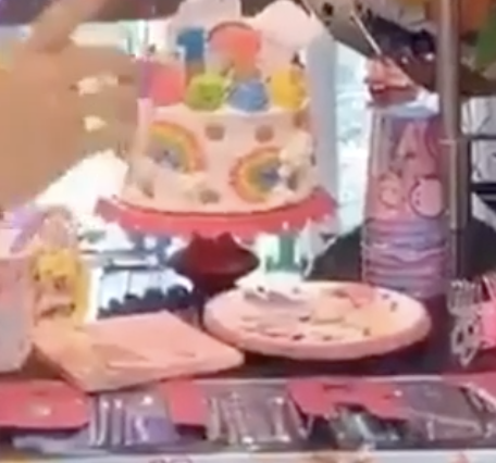 Napkins, plates, and cups with JoJo&#x27;s face on can be seen in the background.