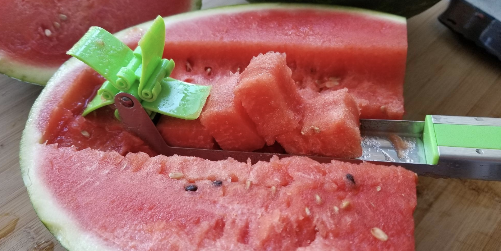 a reviewer pic of stainless steel cutter slicing through watermelon and creating cubes