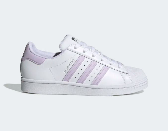 A shoe with a white base and pale purple stripes down the side 