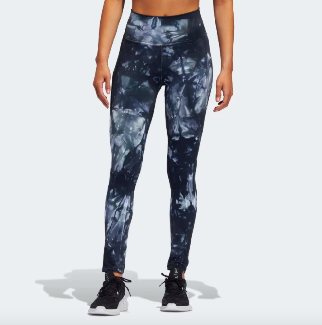 A person wearing the workout tights that look tie-dyed a deep blue color with lighter blues coming through 