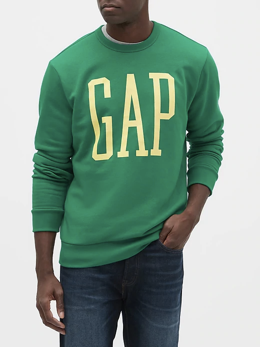 A man wearing a green crewneck sweatshirt with yellow gap logo