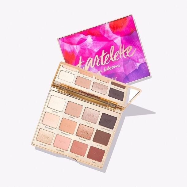 The Tartelette In Bloom Clay Palette with a mirrored compact featuring 12 shades including light nudes, pinks, and browns