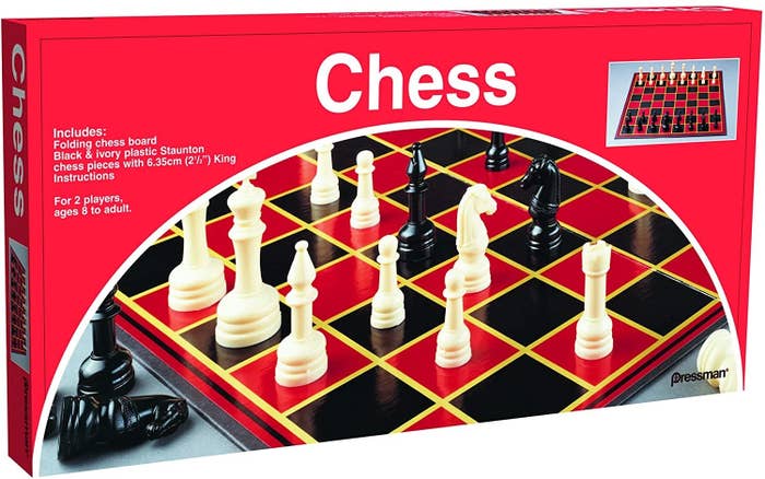 A box of basic chess set with a black and red board and white and black pieces