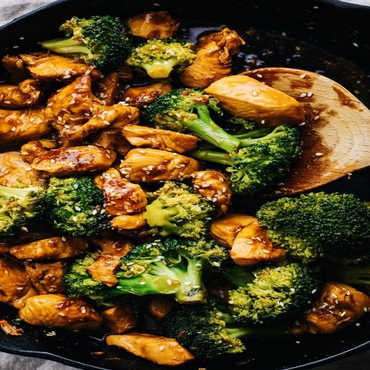 Teriyaki chicken and broccoli cooking in a sauce pan.