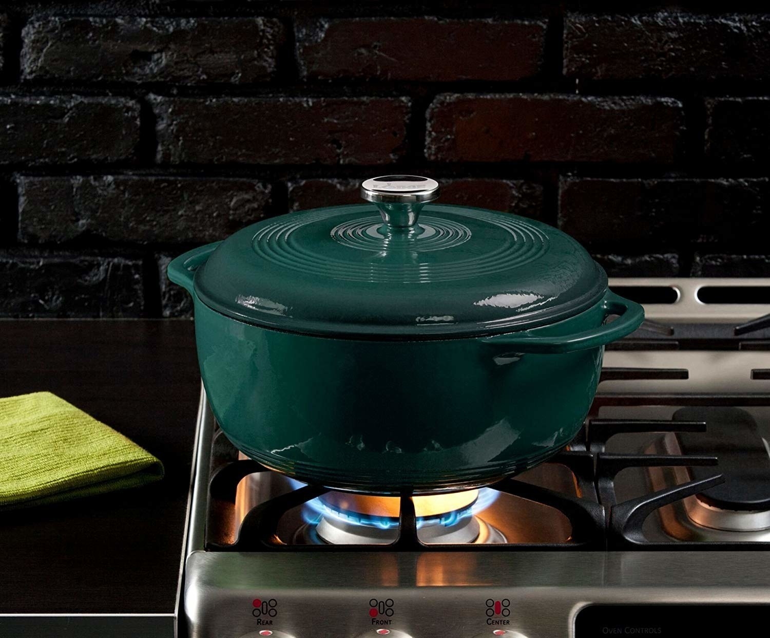 green dutch oven with lid on a stove