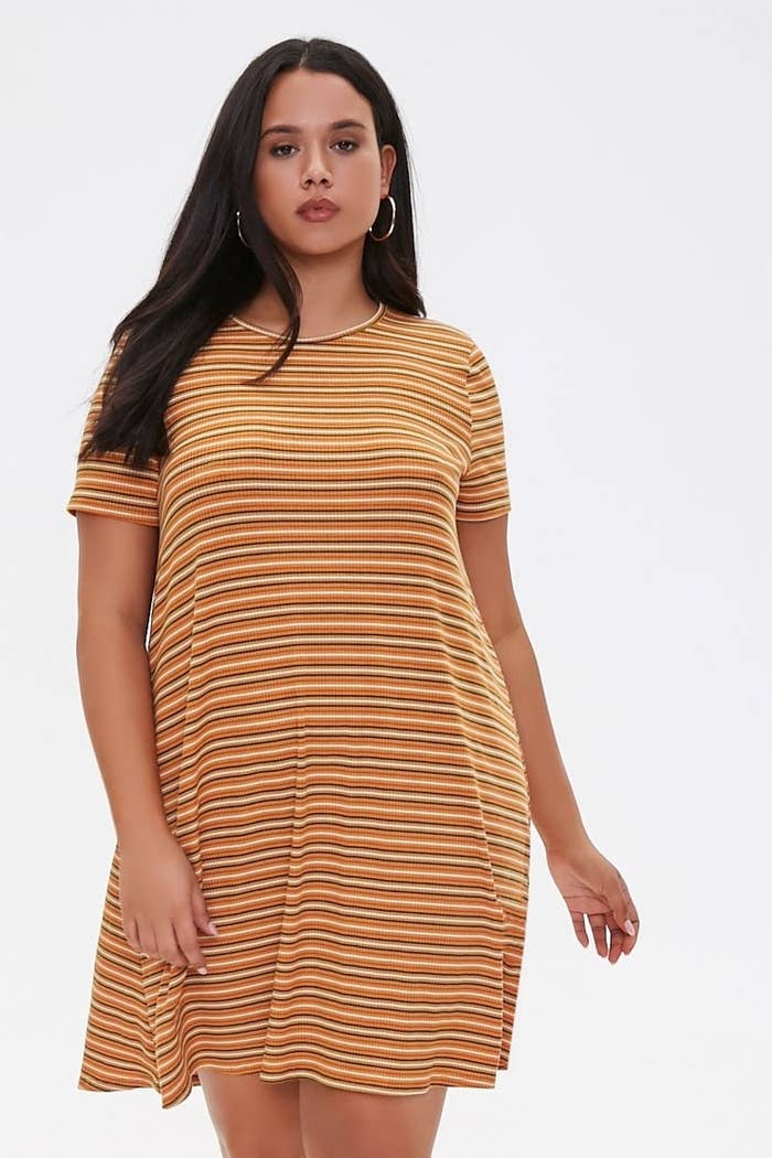 A model wearing the orange and white striped T-shirt dress