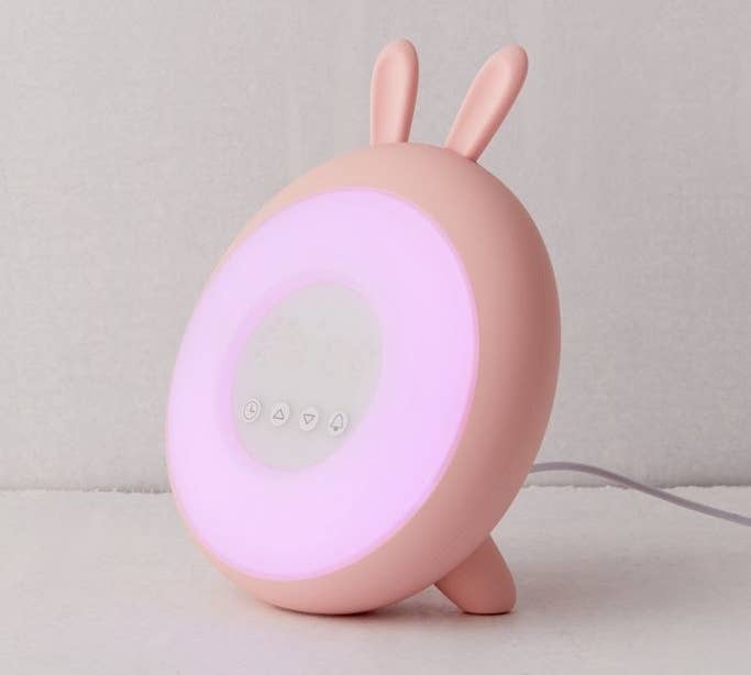 round lighted clock with bunny ears at top