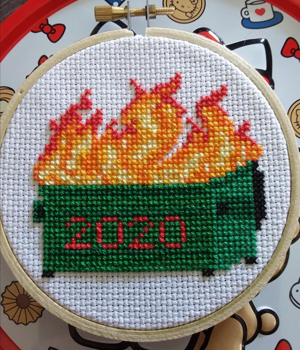 cross-stitch that looks like a dumpster on fire with 2020 on side