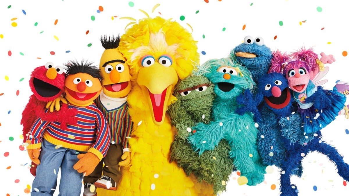 A group image of Sesame Street characters including Elmo, Ernie, Burt, Big Bird, Oscar, Rosita, Cookie Monster, Grover, and Abby Cadabby