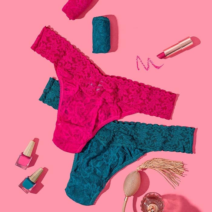Flatlay of two Signature Lace Original Rise thongs in pink and teal