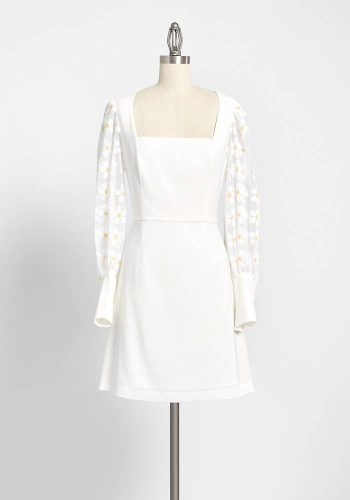 the dress with mesh sleeves and flower appliques 