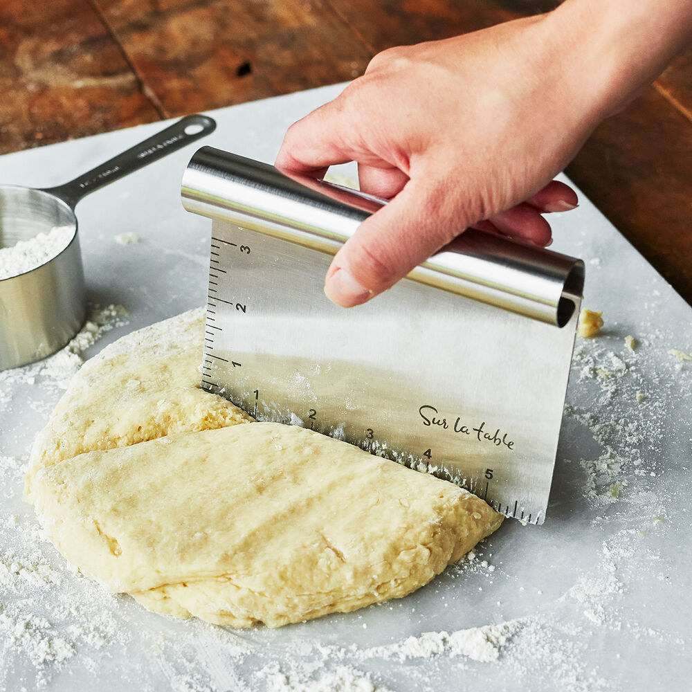 the scrpaper cutting through dough
