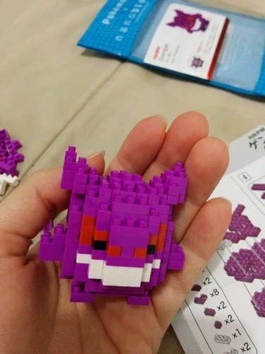 a reviewer holds a small completed gengar in their hand
