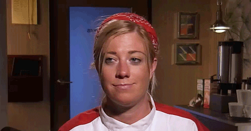 person in chef uniform doing a chef's kiss