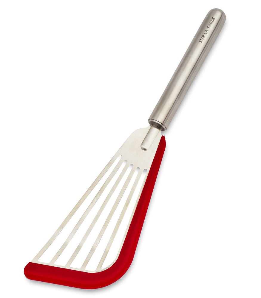 elongated silver spatula with red silicone lining on the front and side