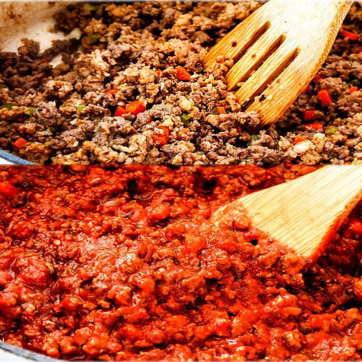 A process shot of cooking Bolognese sauce by adding ground meat and canned tomatoes.