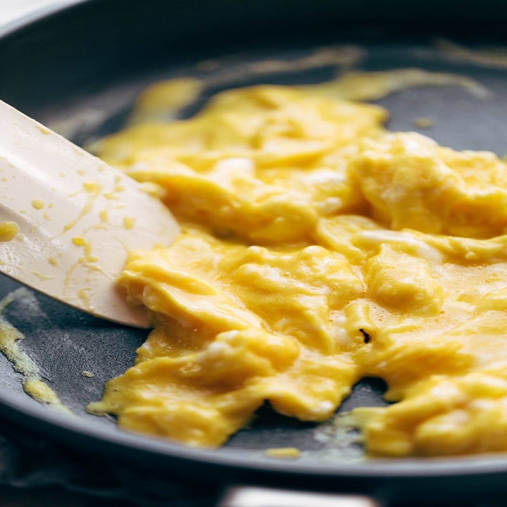 A skillet of super soft scrambled eggs.