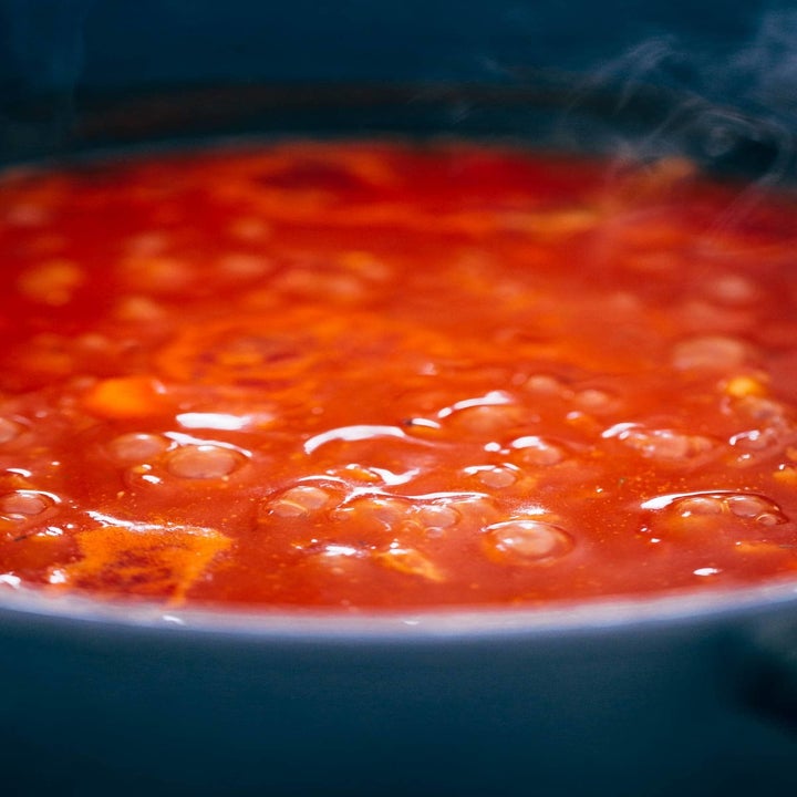 Tomatoes simmering in a pot.