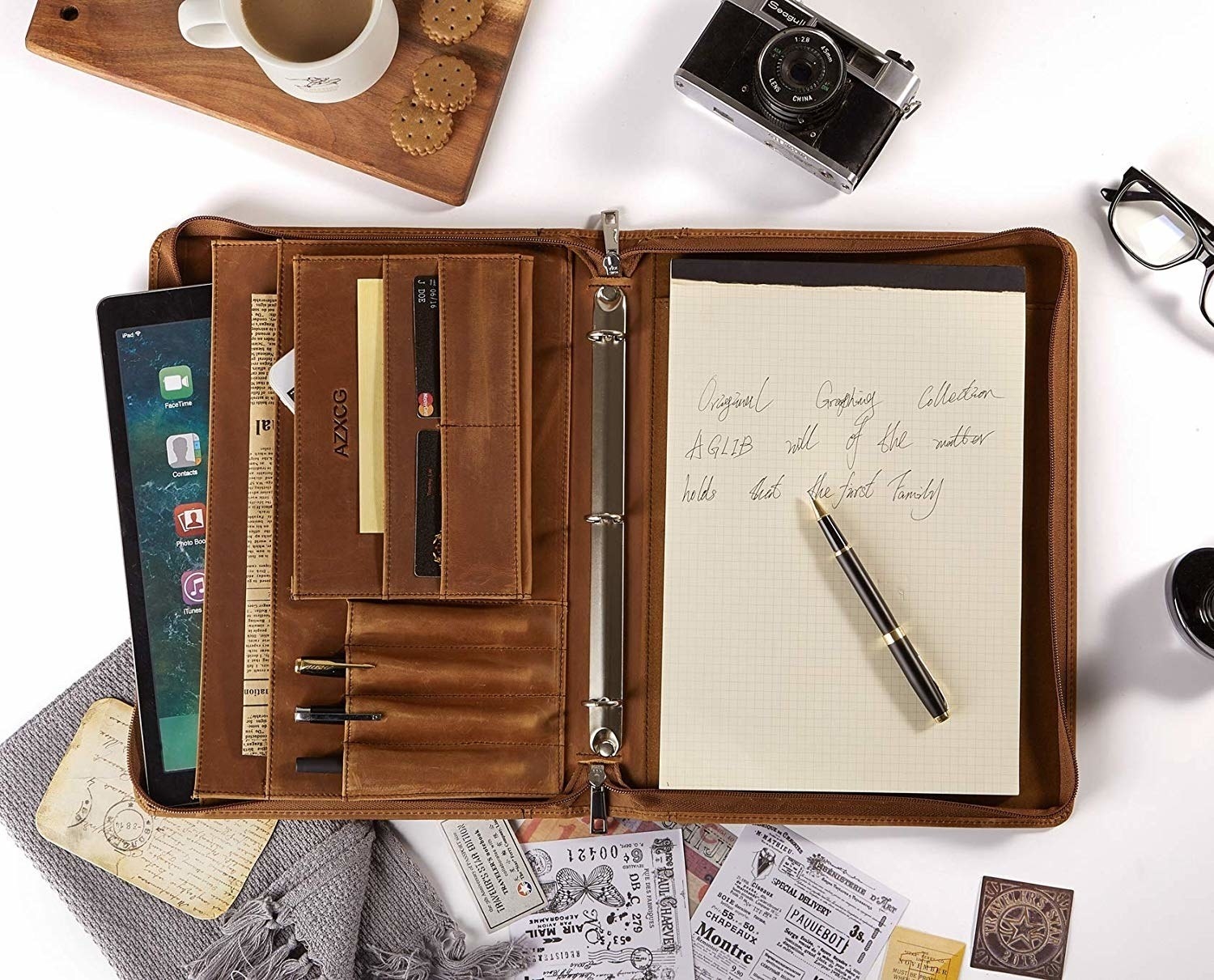The portfolio has pockets, pen holders, card slots, and a three-ring binder