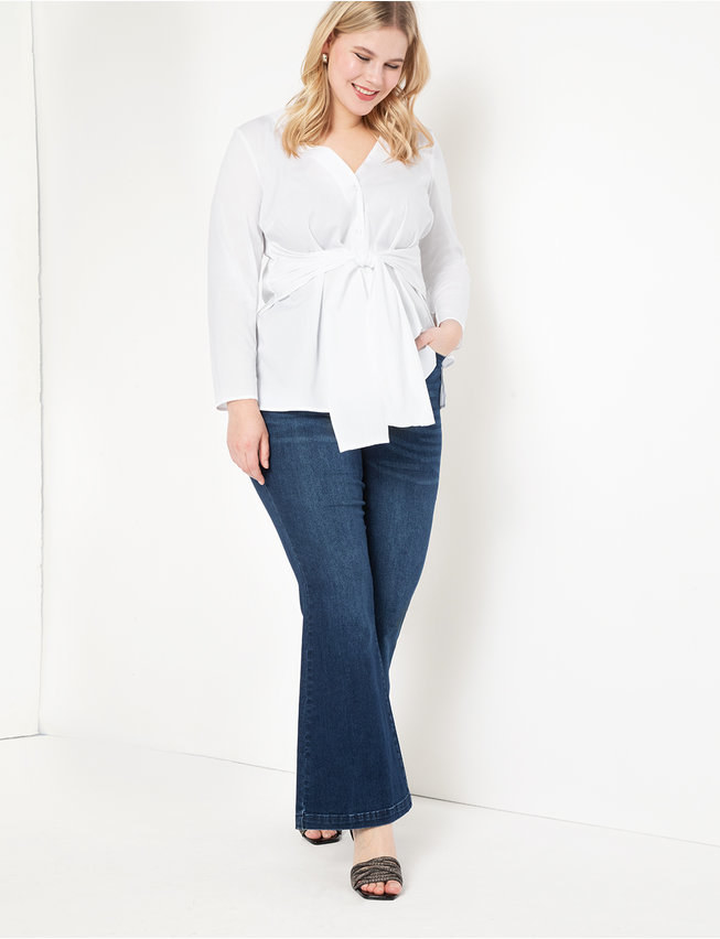 A model wearing the top in white with jeans