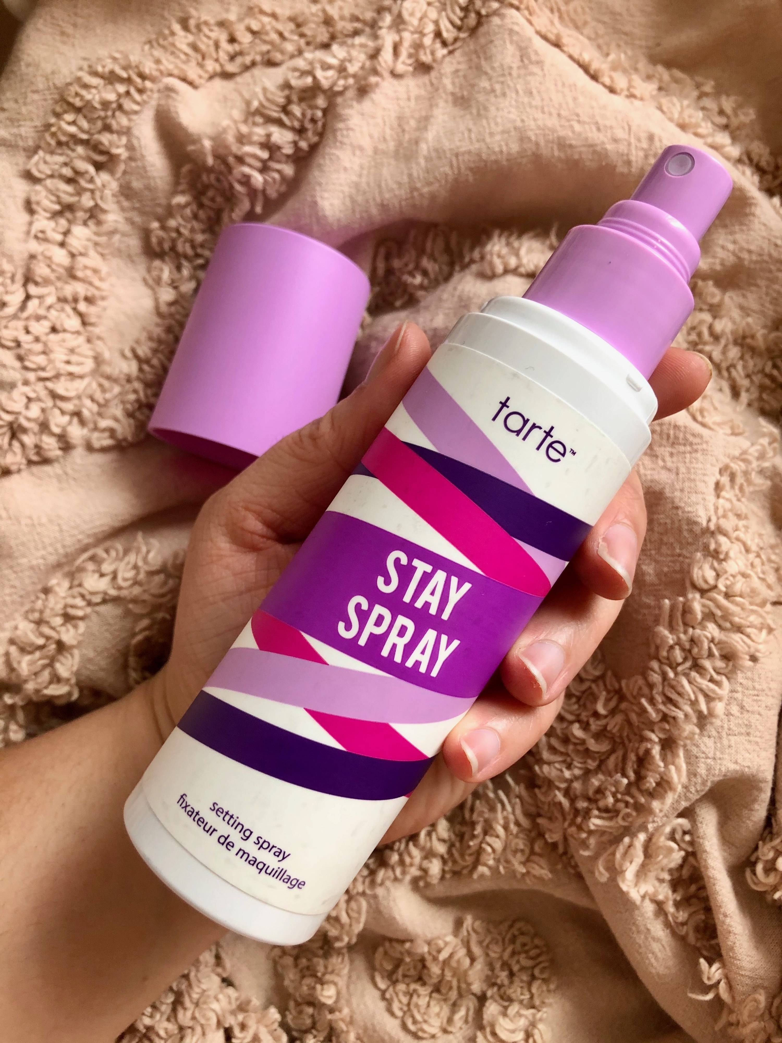 Hand holding the Stay Spray 