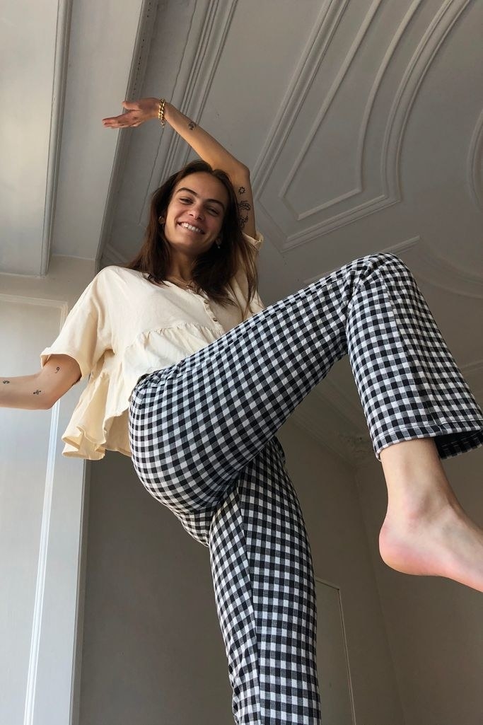 A model showing off the black and white checkered pants